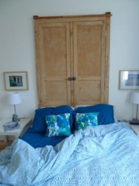 A headboard made with antique wall cupboard doors