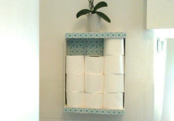 T.P.  Storage never looked more adorable. I made this from a fruit crate that I covered with a patterned material that went with my home decor.