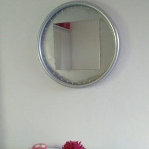 I painted this mirror frame silver after cleaning it, then added decorative little baubles around the inner edge of the frame.